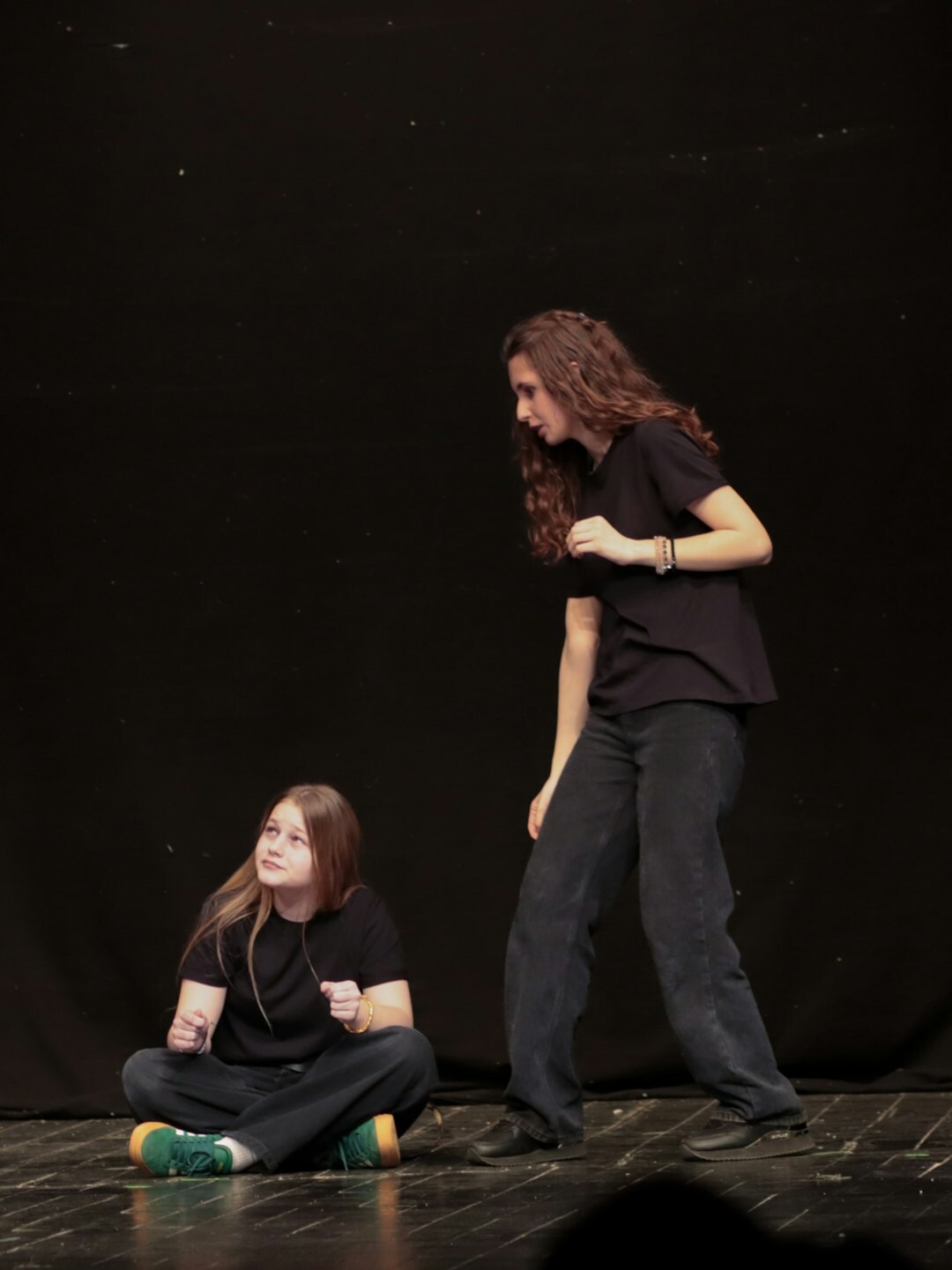 Trainer coaching a student on stage presence